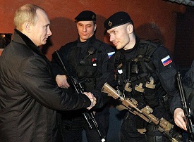 Vladimir Putin shakes hands with the officers of the FSB Alpha Group,during a visit to Gudermes. December 20, 2011